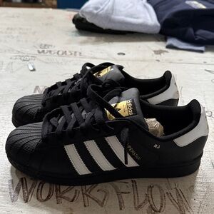 Men’s Adidas Superstar black and gold size 9